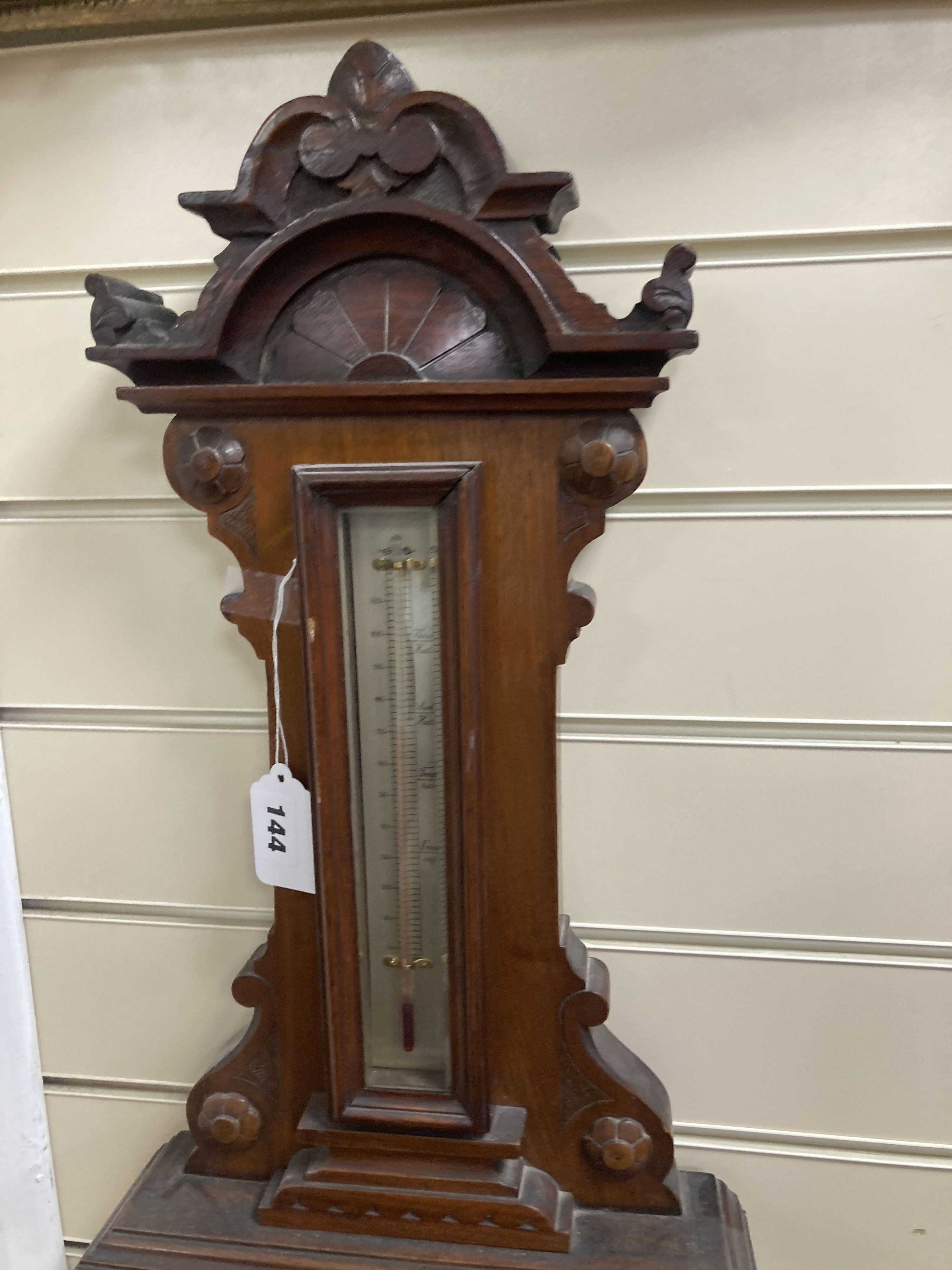 A Victorian carved mahogany wall hanging barometer, the silvered dial marked H. Hughes & Sons, 59 Fenchurch Street, London, height 92cm